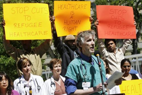 Dr. Michael Dillon, on behalf of Canadian Doctors for Refugee Health Care speaks at a protest at Central Park where local refugees and health care workers gathered to protest federal cuts to refugee health benefits across Canada. 130617 June 17, 2013 Mike Deal / Winnipeg Free Press