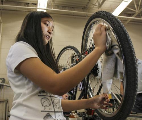 Maples Collegiate Institute student Jamie Hinog, grade 11, put the finishing touches on her bike repairs in the metals workshop today - the last day of an eight week initiative to repair bikes to use and/or donate to the local community to promote active transportation. Education Minister Nacy Allan was in the shop today to announce more than $40 thousand in Education for Sustainable Development (ESD) grants for 22 such projects to promote sustainability and awareness. Tuesday, June 18, 2013. (JESSICA BURTNICK/WINNIPEG FREE PRESS)