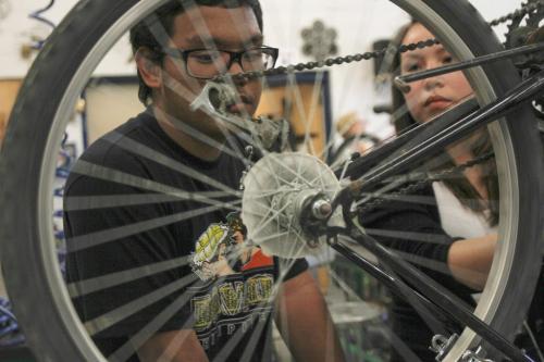 Maples Collegiate Institute 11th grade students Simon Brigole (left) and Molly Bittern put the finishing touches on a bike repair in the metals workshop today - the last day of an eight week initiative to repair bikes to use and/or donate to the local community to promote active transportation. Education Minister Nacy Allan was in the shop today to announce more than $40 thousand in Education for Sustainable Development (ESD) grants for 22 such projects to promote sustainability and awareness. Tuesday, June 18, 2013. (JESSICA BURTNICK/WINNIPEG FREE PRESS)