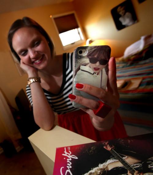 Danielle Mymko, a Taylor Swift "Superfan" poses in her bedroom with some of her TS "stuff" here a cell phone cover. See Carolyn Vesely story. June 18, 2013 - (Phil Hossack / Winnipeg Free Press)