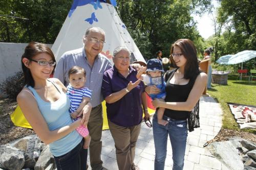 From left, Brandy Andrews with daughter Isabella, Elders Clarence and Barbara Nepinak and Victoria Dorie with son Caleb by the teepee in The Villa Rosa Outdoor Teaching Garden . Villa Rosa held a grand opening ceremony for the garden Wednesday.   Intern Elizabethstory. (WAYNE GLOWACKI/WINNIPEG FREE PRESS) Winnipeg Free Press June 19 2013