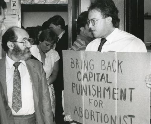 Dr. Henry Morgentaler comes face-to-face with an anti-abortionist as he emerges from courtroom. July 15, 1983.  Jim Wiley / Winnipeg Free Press