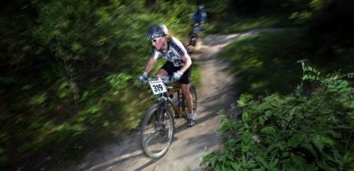 On the hunt,Cindy Braun # 319  muscles around a turn on the trails at the "Dirt Skirt" Mountain Bike Race race at Bird's Hill Park Wednesday evening. See Kyle Jahns story. Jume 19, 2013 - (Phil Hossack / Winnipeg Free Press)