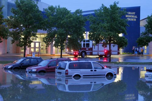 Flash flooding in the parking lot of Grant Memorial Church. BORIS MINKEVICH / WINNIPEG FREE PRESS. June 20, 2013