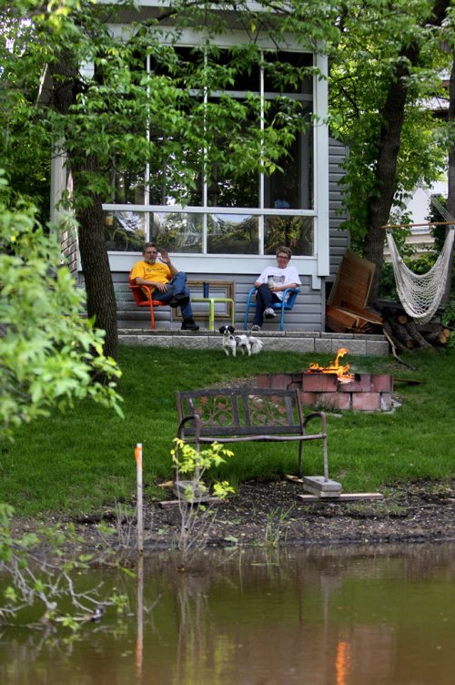 Trip down the Seine River from the Perimeter through St Vital and St. Boniface to  where it feeds into the Red River just north of the Forks.  Trip taken in early June 2013.  Susan and Joe Lucas  enjoy sitting by a fire along the river after a day of yard work.  Photography by Ruth Bonneville Winnipeg Free Press Edited on June  20, 2013