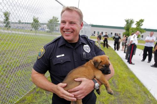 Winnipeg Police Service Canine Unit grand opening. Police officer from the USA Jeramy Halek with one of the dogs. IN STORY.  BORIS MINKEVICH / WINNIPEG FREE PRESS. June 21, 2013