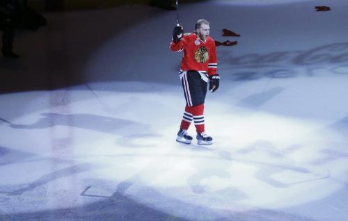 Chicago Blackhawks right wing Patrick Kane (88) acknowledges the crowd as he is named as the number one star of the game after the Blackhawks beat the Boston Bruins 3-1 in Game 5 of the NHL hockey Stanley Cup Finals, Saturday, June 22, 2013, in Chicago. Kane scored two of Chicago's three goals. (AP Photo/Charles Rex Arbogast)