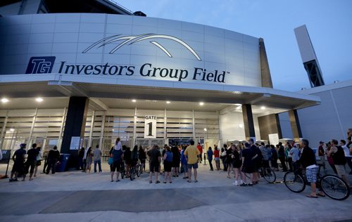 Those without tickets watch Taylor Swift through the gates at Investors Group Field, Saturday, June 22, 2013. (TREVOR HAGAN/WINNIPEG FREE PRESS)