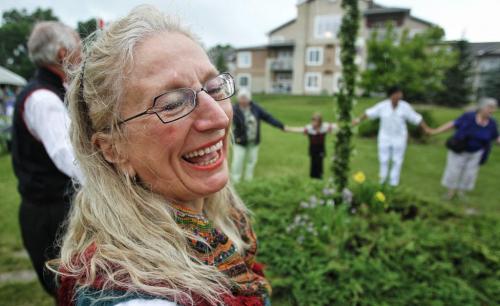 Carol Simonson Gunvaldsen turns her face up to the rain and laughs while dancing around the Maypole during the Swedish Midsommar picnic at Vasa Lund Park Sunday afternoon.  130623 June 23, 2013 Mike Deal / Winnipeg Free Press