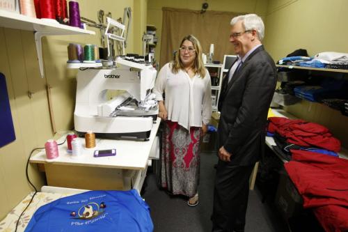 Fin. -Greg Selinger NDP Newser -  Michelle Cameron of Dreamcatcher Promotions shows Greg Selinger new computerized sewing machines - , jobs were created by  leveraging investment in the first 5 years  by First Peoples Economic Growth Fund- DCP uses an automated  sewing machine for embroided clothing  -Cash story -  KEN GIGLIOTTI / JUNE 24 2013 / WINNIPEG FREE PRESS