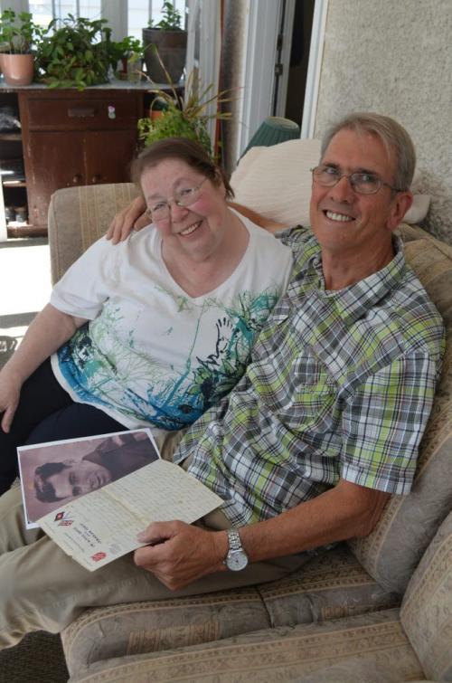 Sheila Cramer and long-lost and finally found half brother Peter Westcott of England look over love letter from their father to Peter's mother during WW2. - there are other photos on file of the shared father and the two mothers. June 24, 2013 (Gordon Sinclair Jr/ Winnipeg Free Press)