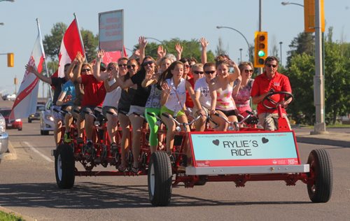Brandon Sun Rylie Basaraba, 14, sitting in the centre front of the bike, was joined by her family and friends on the Big Bike Ride for the Heart and Stroke Foundation on Monday night. Team Rylie's Ride have participated in the Big Bike Ride event following Rylie's stroke at the age of eleven during a soccer game. The road to recovery has been tough, but Basaraba is back to doing things she used to do like dance with Steppin' Time Dance Studio. The Big Bike will be at the Canad Inns with teams making a lap around the Keystone Centre grounds. (Bruce Bumstead/Brandon Sun)