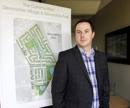 Dave Boles, development manager for Genstar Development Company, with site development drawings for one of the two major new developments that the company has planned for a tract of vacant land north of the Costco store on Regent Ave. West on Tuesday, June 25, 2013. (MCNEILL) (JESSICA BURTNICK/WINNIPEG FREE PRESS)
