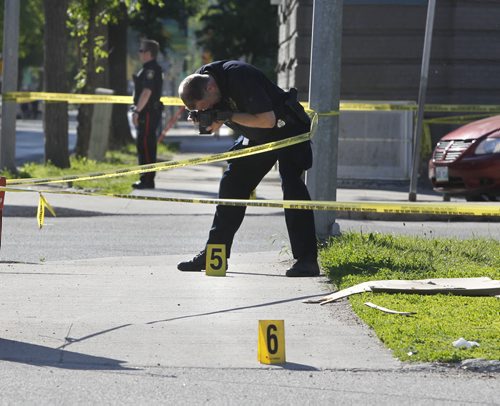 Winnipeg Police have three sections of sidewalk taped off near the Balmoral  Hotel's beer store on Cumberland Ave. at Kennedy St. Tuesday morning. Wayne Glowacki/Winnipeg Free Press June 25 2014