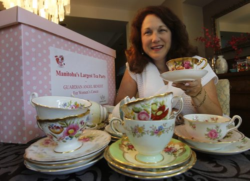 Sandra Lorange is organizing a tea cup fundraiser with Safeway to benefit Cancer Care. She is with some of the cups and saucers collected so far. It will be called Manitoba's Largest Tea Party, the Guardian Angel Benefit For Women's Cancer, Safeway stores will have collection boxes like the one at left.  Lindor Reynolds  story (WAYNE GLOWACKI/WINNIPEG FREE PRESS) Winnipeg Free Press June 25 2013