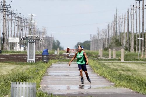 With the current UV index at 7 (high) and humidity at 45%, it's no wonder rollerblader Houston Rennie, 18, appears as though out of a mirage on Tuesday, June 25, 2013. Temperatures are expected to hit a high of 31 degrees Celsius today. (JESSICA BURTNICK/WINNIPEG FREE PRESS)