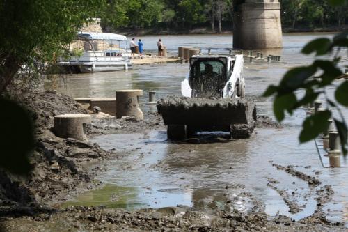 Crews remove sloppy clay from the River Walk at the Forks Tuesday afternoon.  Due to a late spring the water levels at the Forks are higher than usual.    June 25, 2013 Ruth Bonneville , Winnipeg Free Press