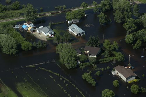 Brandon Sun 26062013 Homes in the community of Reston, Manitoba are inundated with water after severe flooding as seen from the air on Wednesday. (Tim Smith/Brandon Sun)