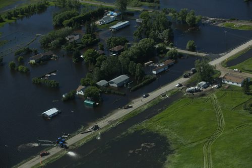 Brandon Sun 26062013 Homes in the community of Reston, Manitoba are inundated with water after severe flooding as seen from the air on Wednesday. (Tim Smith/Brandon Sun)