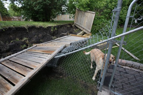 Brandon Sun Soaked ground and wind combined to topple this retaining wall as well as the fence in the background, on Antelope Bay in Brandon on Tuesday evening. People throughout Westman continue to assess damage and clean up after the third torrential downpour in four days. (Tim Smith/Brandon Sun)