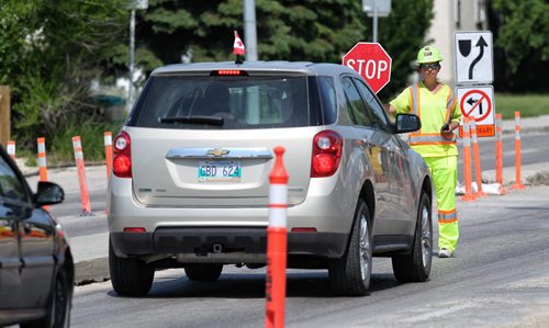 Flagger, Jodi Mousseau, working construction on St. Mary's Road Tuesday afternoon. After the recent acquittal of the driver who killed a highway flag person, flaggers just want people to slow down. 130702 July 02, 2013 Mike Deal / Winnipeg Free Press