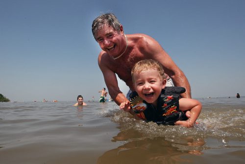 Picture Perfect moment- Grandfather Brian Connelly cools off his grandson Cruz Sexsmith  to beat the +30 C weather at Grand Beach Wednesday afternoon  - Cruz  turns 4 on Thursday-Standup photo- July 03, 2013   (JOE BRYKSA / WINNIPEG FREE PRESS)