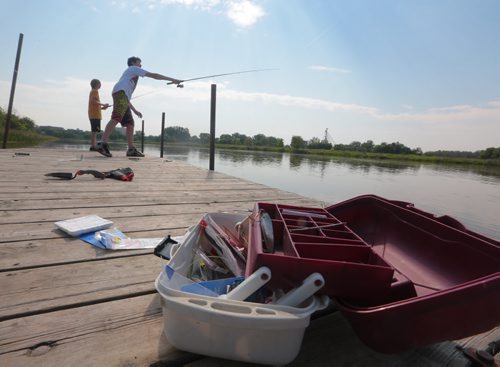Brandon Sun Friends Paul MacKay and Nolan May, right, spend the afternoon fishing along the Assiniboine River near Disdale Park on Friday. (Bruce Bumstead/Brandon Sun)