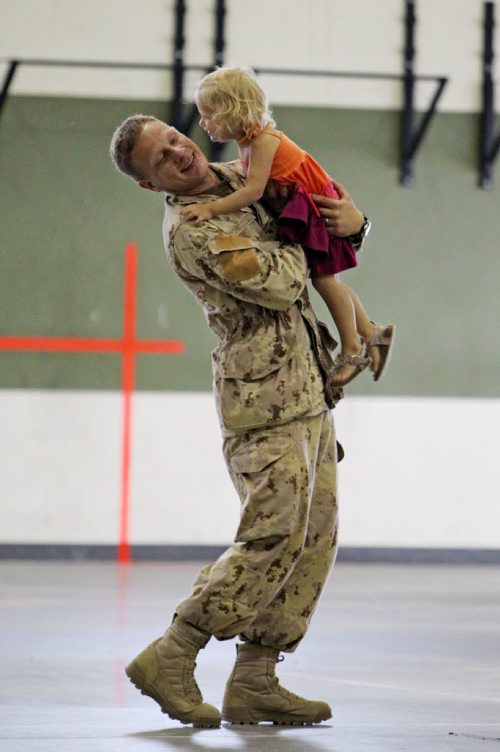 Brandon Sun 08072013 Corporal Krister Pohjolainen plays with his two-year-old daughter Elise in the Multi-Purpose Training Facility at CFB Shilo on Monday morning prior to deploying to Kabul as part of the final rotation of Canadian soldiers serving in Afghanistan. Pohjolainen's deployment, his first to Afghanistan, will be approximately four month's.  (Tim Smith/Brandon Sun)