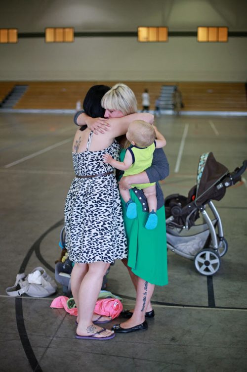Brandon Sun 08072013 Military wives Callie Gardiner and Mandy Burton comfort each other after watching their husbands leave the Multi-Purpose Training Facility at CFB Shilo on Monday morning to serve as part of the final rotation of Canadian soldiers serving in Afghanistan.   (Tim Smith/Brandon Sun)