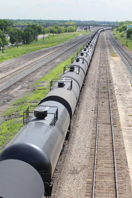 Brandon Sun 08072013 A long line of tanker cars sit on a set of Canadian Pacific railway tracks that run through Brandon adjacent to Pacific Ave. on Monday. (Tim Smith/Brandon Sun)