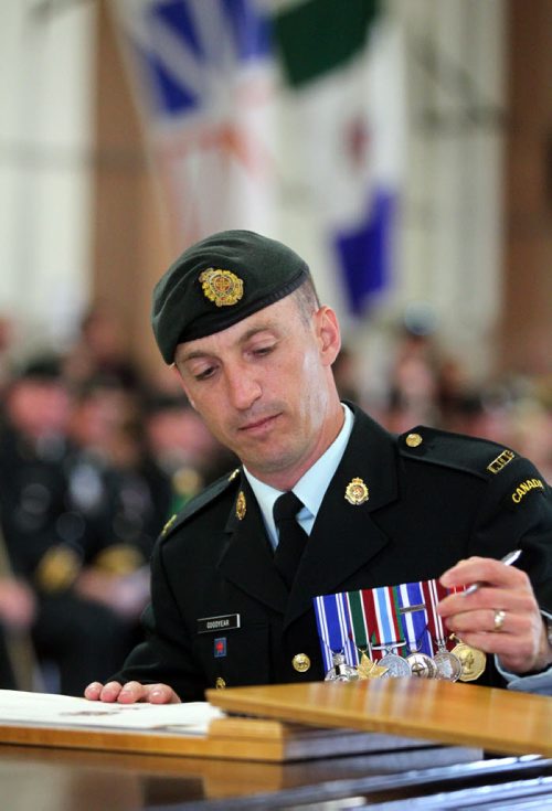 Brandon Sun Outgoing Base Commader Lt-Col. Richard Goodyear signs the official Change of Command documents during a ceremony held at CFB/ASU Shilo on Tuesday morning. Lt-Col. Goodyear joined the Canadian Forces in 1990 and graduated from the Royal Military College in 1996 with a Bachelor of Commerce. He has served as Base Commander since June 2011. (Bruce Bumstead/Brandon Sun)