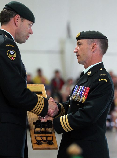 Brandon Sun A tradition in the artillery, the unit's branding iron is given to the outgoing commanding officer which was presented my 1 Area Support Group commanding office Col. Derek Macauley to Lt-Col. Richard Goodyear. (Bruce Bumstead/Brandon Sun)