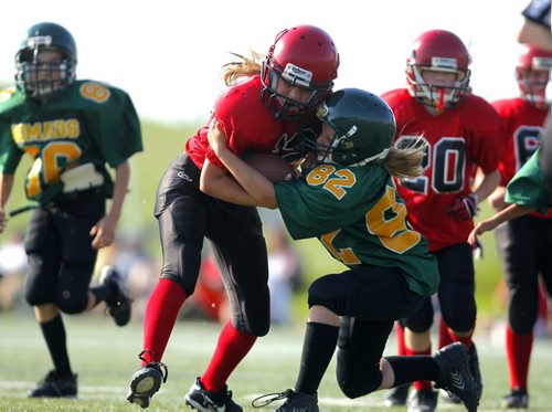 Manitoba Girls Football Association league play between the St. Vital Mustangs and the North Winnipeg Nomads Jr teams. The MGFA is a stand alone program that gives girls that want to play against other girls the oppotunity and still alows the girls that wish to play fall football to do so. #12 Brenna Hargrave gets tackled. BORIS MINKEVICH / WINNIPEG FREE PRESS June 19, 2013