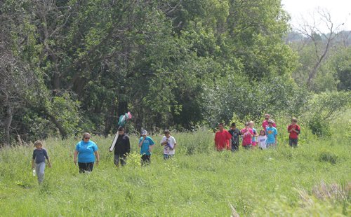 Brandon Sun Children in the Brandon University outdoor education Mini-U program make their way along the edge of the duck ponds in search of aquatic critters at the Riverbank Discovery Centre on Wednesday afternoon. (Bruce Bumstead/Brandon Sun)