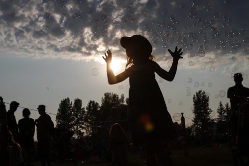 Avery MacKenzie, 6, tries to catch bubbles on Day 1 at the Winnipeg Folk Festival. Wednesday, July 10, 2013. (JESSICA BURTNICK/WINNIPEG FREE PRESS)