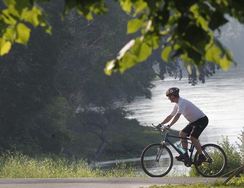 A bike ride by the Assiniboine River on a sunny warm Thursday morning is a perfect way to start the day. Wayne Glowacki / Winnipeg Free Press July 11 2013