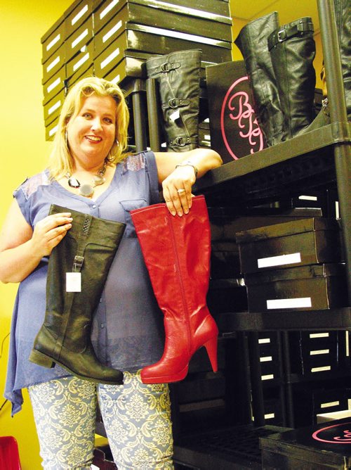Canstar Community News Pamela Ammeter displays two of the new boot styles that she plans to offer through Boots By Pamela this fall. (ANDREA GEARY/CANSTAR COMMUNITY NEWS)