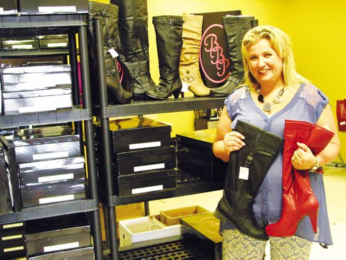 Canstar Community News Pamela Ammetere of Headingley holds two of the new boot styles she plans to offer this fall. ANDREA GEARY/CANSTAR COMMUNITY NEWS