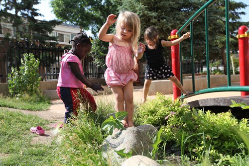 Young children learn to balance themselves on natural structures at Manidoo - Lord Selkirk Park Childcare Centre where children enjoy an interactive environment that will help them fair better once they enter the school system.   See Carol Sanders story for Saturday special.  July 11 , 2013 Ruth  Bonneville , Winnipeg Free Press