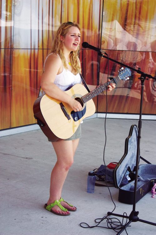 Canstar Community News Windsor Park resident Mikayla Zacharias performs a tune during the Transcona BIZ Market Garden opening at the Transcona Centennial Square on July 4. (DAN FALLOON/CANSTAR COMMUNITY NEWS)