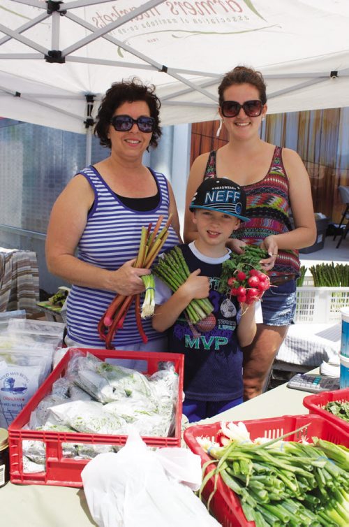 Canstar Community News Thelma Neumann, Ty Neumann, and Jessica Bonneteau of Neumann's Market display their wares at the Transcona BIZ Market Garden on July 4. (DAN FALLOON/CANSTAR COMMUNITY NEWS)