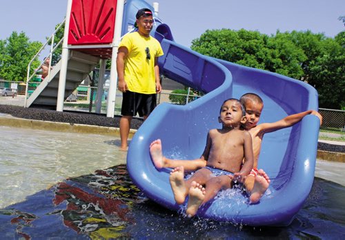 Canstar Community News July 4, 2013 -- Three-year-old Dilpreet Sidhu gets a suprise bump while cooling down in the wading pool at the Shaughnessy Spray Pad July 4. (MATT PREPROST/CANSTAR NEWS)
