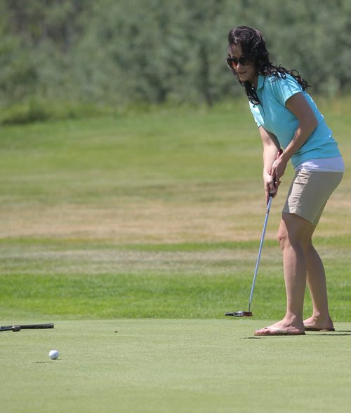 Brandon Sun Nycolle Adams of J&G Homes, sends a putt to the hole during Thursday's Westman Dreams for Kids charity golf tournament held at the Shilo Golf Course. (Bruce Bumstead/Brandon Sun)