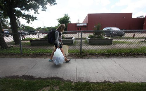 Naomi carries her bags of school supplies home as she leaves Windsor School for the last time.  Grade 8 Windsor School students  spend the final moments on the last day of school writing in each others yearbooks, cleaning out lockers and sharing tearful goodbyes as they transition from grade school to High School in the fall of this year.  Some of the students have been attending Windsor School  with the same group of friends since kindergarden. Although most of the students will be going to Glenlawn Collegiate some have plans to attend a different high school.  Photo's taken on June 28, 2013 Class of 2017 Doug Speirs story.  July 11 , 2013 Ruth  Bonneville , Winnipeg Free Press