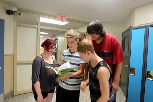 Shelby, Liam, Griffin and classmate look through the yearbook together. Grade 8 Windsor School students  spend the final moments on the last day of school writing in each others yearbooks, cleaning out lockers and sharing tearful goodbyes as they transition from grade school to High School in the fall of this year.  Some of the students have been attending Windsor School  with the same group of friends since kindergarden. Although most of the students will be going to Glenlawn Collegiate some have plans to attend a different high school.  Photo's taken on June 28, 2013 Class of 2017 Doug Speirs story.  July 11 , 2013 Ruth  Bonneville , Winnipeg Free Press