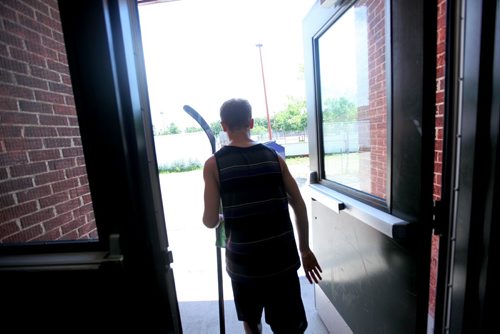 Griffin carries his hockey stick and his yearbook as he leaves Windsor School for the last time.  Grade 8 Windsor School students  spend the final moments on the last day of school writing in each others yearbooks, cleaning out lockers and sharing tearful goodbyes as they transition from grade school to High School in the fall of this year.  Some of the students have been attending Windsor School  with the same group of friends since kindergarden. Although most of the students will be going to Glenlawn Collegiate some have plans to attend a different high school.  Photo's taken on June 28, 2013 Class of 2017 Doug Speirs story.  July 11 , 2013 Ruth  Bonneville , Winnipeg Free Press