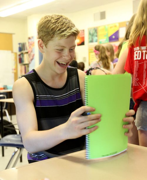 Griffin smiles as he reads some messages left on his yearbook on the last day of school.  Grade 8 Windsor School students  spend the final moments on the last day of school writing in each others yearbooks, cleaning out lockers and sharing tearful goodbyes as they transition from grade school to High School in the fall of this year.  Some of the students have been attending Windsor School  with the same group of friends since kindergarden. Although most of the students will be going to Glenlawn Collegiate some have plans to attend a different high school.  Photo's taken on June 28, 2013 Class of 2017 Doug Speirs story.  July 11 , 2013 Ruth  Bonneville , Winnipeg Free Press