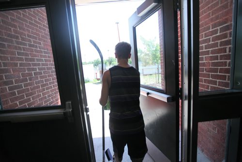 Griffin carries his hockey stick and his yearbook as he leaves Windsor School for the last time.  Grade 8 Windsor School students  spend the final moments on the last day of school writing in each others yearbooks, cleaning out lockers and sharing tearful goodbyes as they transition from grade school to High School in the fall of this year.  Some of the students have been attending Windsor School  with the same group of friends since kindergarden. Although most of the students will be going to Glenlawn Collegiate some have plans to attend a different high school.  Photo's taken on June 28, 2013 Class of 2017 Doug Speirs story.  July 11 , 2013 Ruth  Bonneville , Winnipeg Free Press