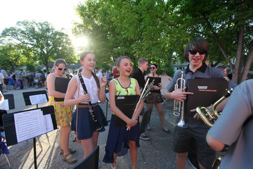 Grade 8 Windsor School band students  gather up their instruments and head back into school after they performed for parents and teachers outside the school for the last time before they graduate into high school. Students in foreground of photo - Left - Right Sydney, Aby and Garrett. Class of 2017 Doug Speirs story.  July 11 , 2013 Ruth  Bonneville , Winnipeg Free Press