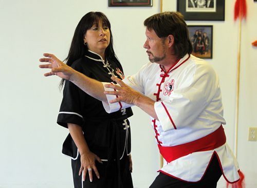 WOMEN'S SELF DEFENSE - Sifu Peggy McRitchie teaches a women's self defense course out of the new location of Plum Blossem Martial Arts Academy on Pembina Highway. (Sifu is title she has for martial arts). The guy (Brian Dupuis) in the photo is part of the club and poses as the attacker.  BORIS MINKEVICH / WINNIPEG FREE PRESS July 10, 2013